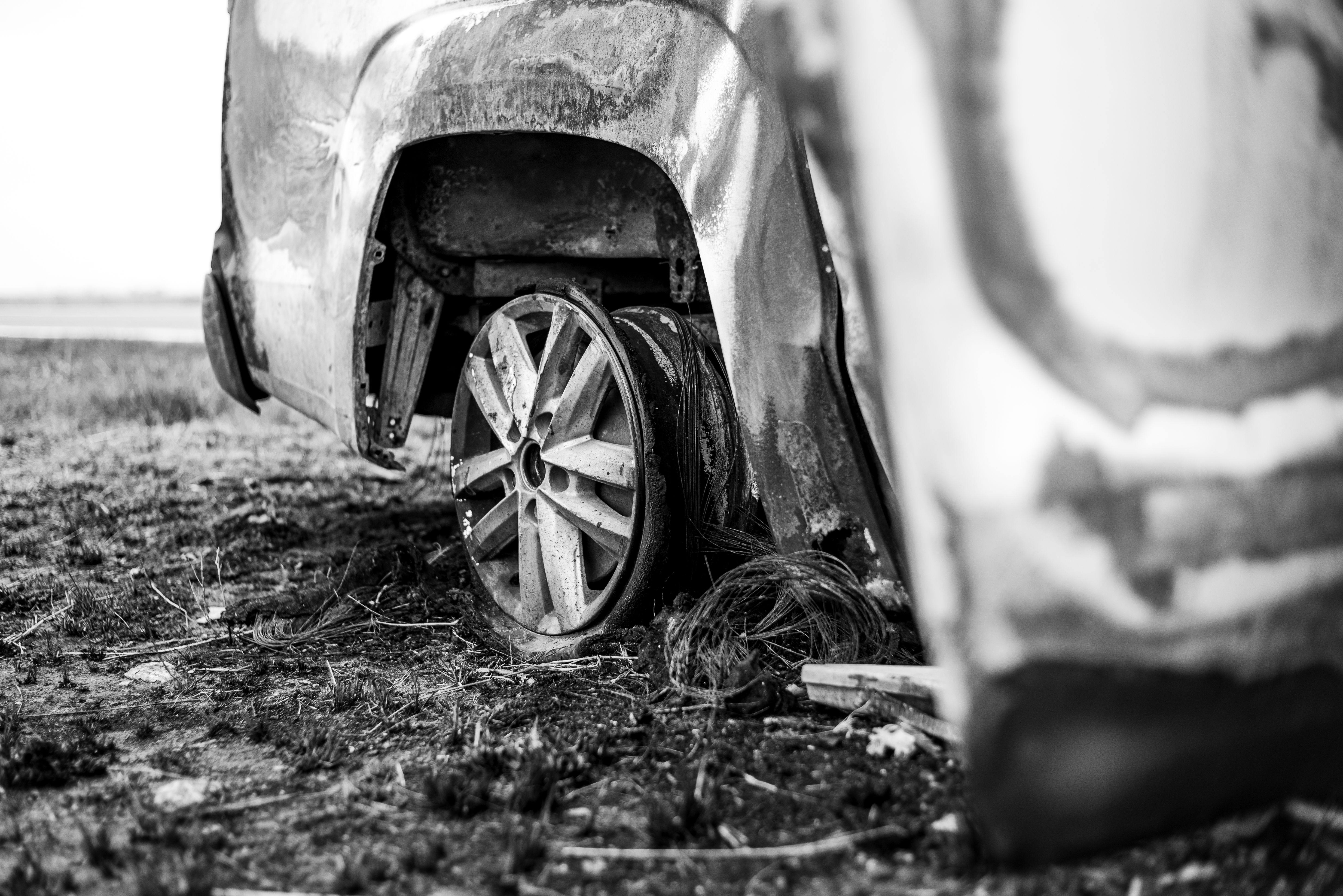 Damaged vehicle at a roadside crash scene.