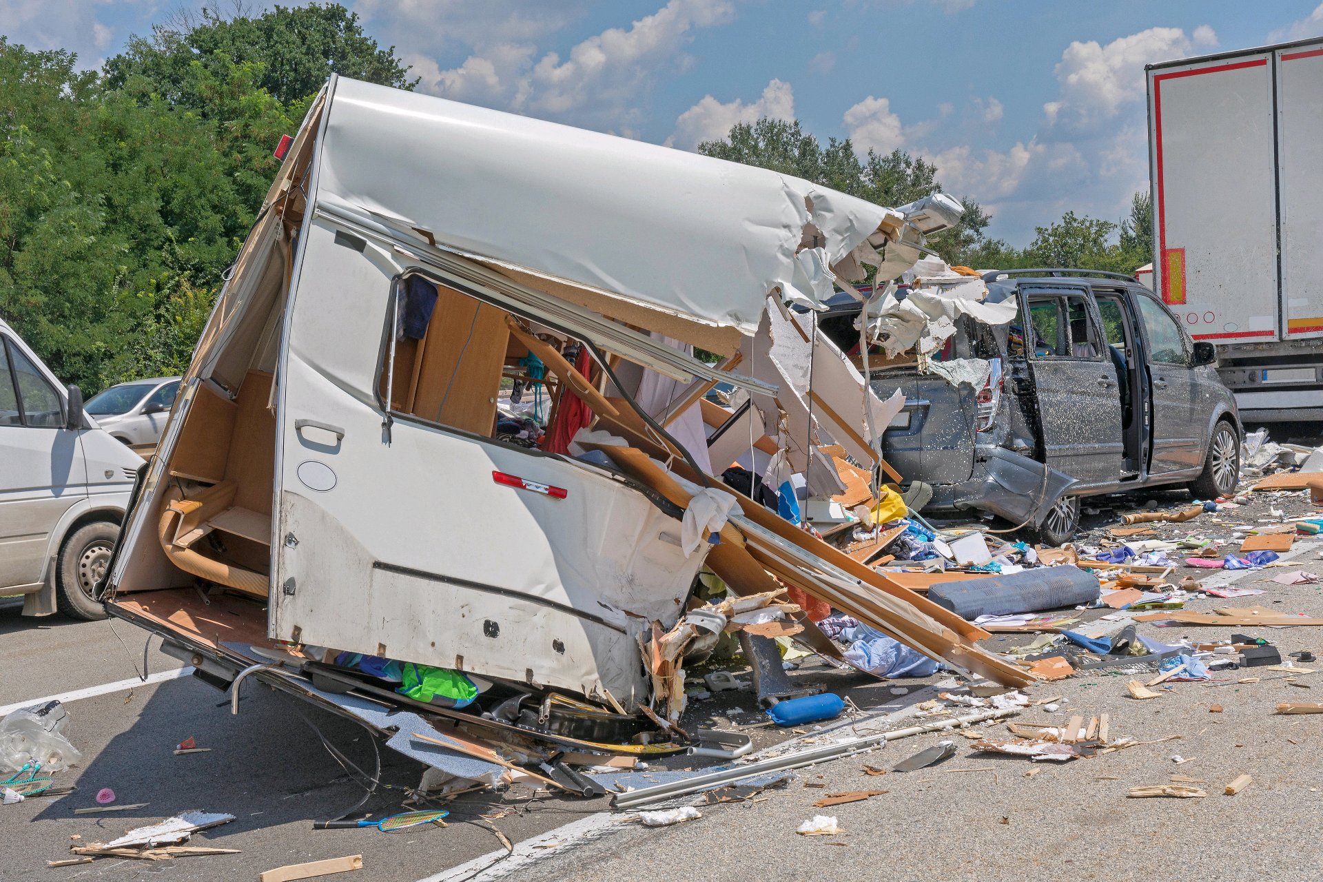 Damaged pickup and commercial truck at a roadway crash scene.