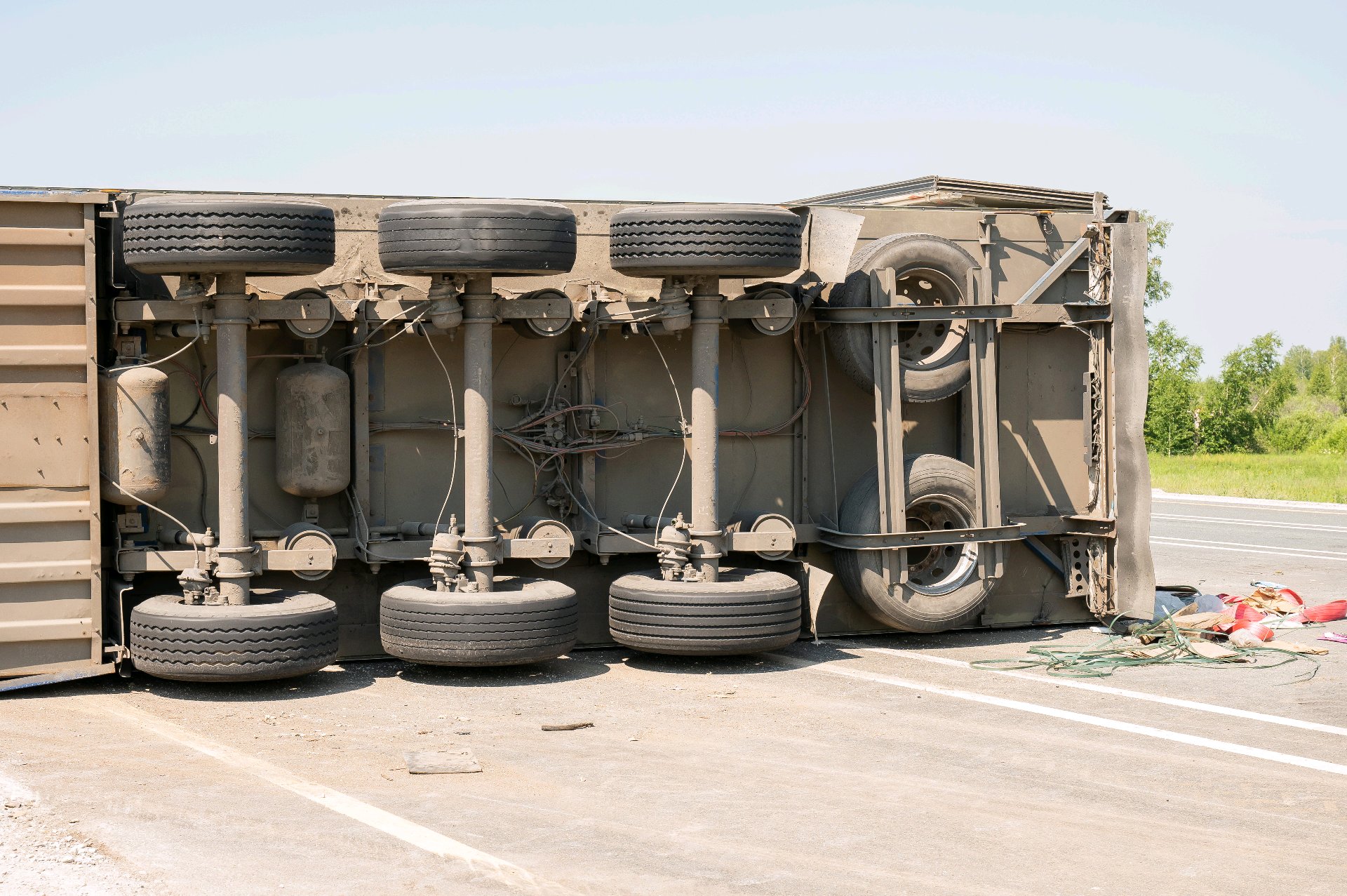 Illustrative overturned commercial trailer on a roadway after a crash.