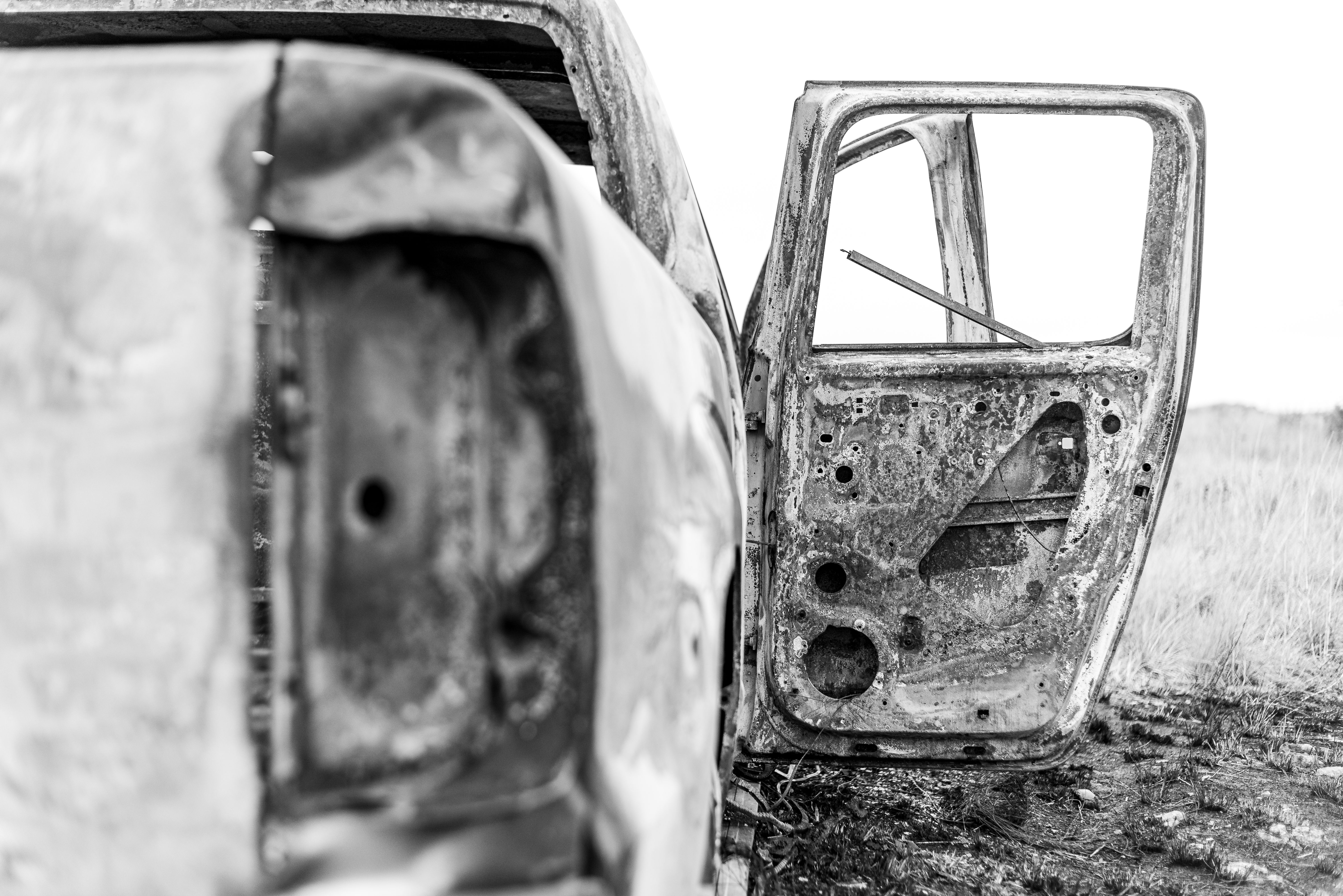 Illustrative damaged vehicle door at a rural roadside crash scene.